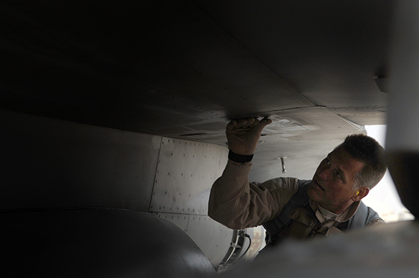 rig. Gen. Brian Bishop, 332nd Air Expeditionary Wing commander, inspects various panels on an F-16 Fighting Falcon before his first combat mission over Iraq here, July 7. Inspecting the fighter aircraft before each flight is part of a process to ensure that the jet is clear from any maintenance issues. General Bishop is flying with the 77th Expeditionary Fighter Squadron deployed from Shaw Air Force Base, S.C.